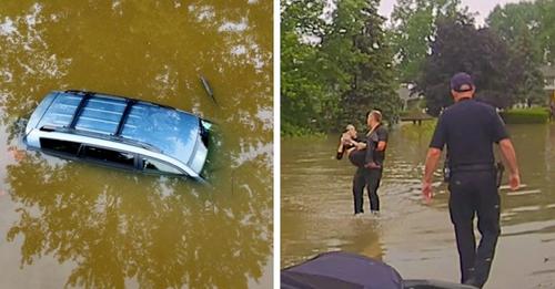 Drei Polizisten schwimmen, um eine in ihrem Auto gefangene 82 jährige Frau aus einer Überschwemmung zu retten