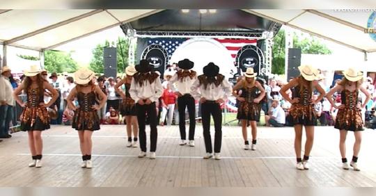 Gruppe von Stepptänzern in Cowboy-Kleidung tanzt zu einzigartiger Version von 'Country Roads'